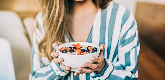 patient eating a healthy cereal after receiving diet guidance from Campbell chiropractor