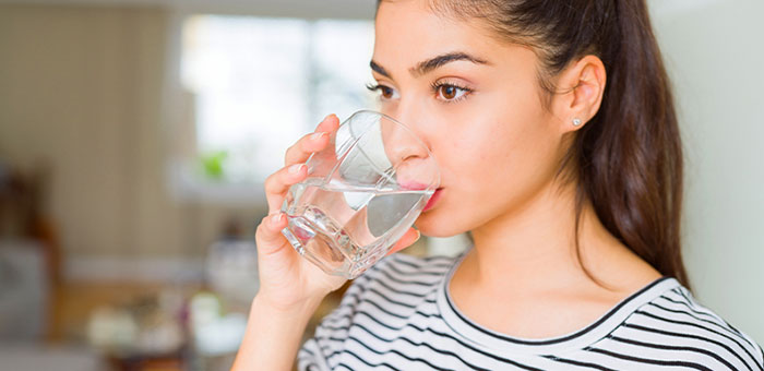 patient drinking water to be healthy under the guidance of Campbell chiropractor