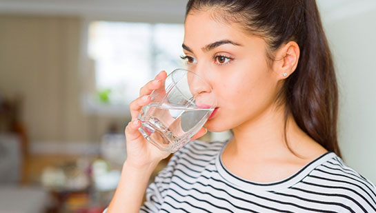 patient drinking water to be healthy under the guidance of Campbell chiropractor