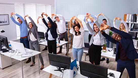 office team stretching together under guidance of Campbell chiropractor